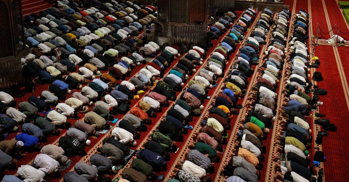 Large group of people praying in a mosque in Jakarta, Indonesia.
